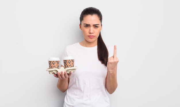 Pretty hispanic woman feeling angry annoyed rebellious and aggressive take away coffee concept