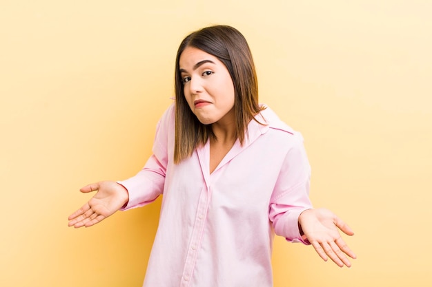 Pretty hispanic woman feeling clueless and confused having no idea absolutely puzzled with a dumb or foolish look