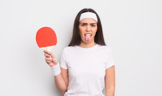 Pretty hispanic woman feeling disgusted and irritated and tongue out. ping pong concept