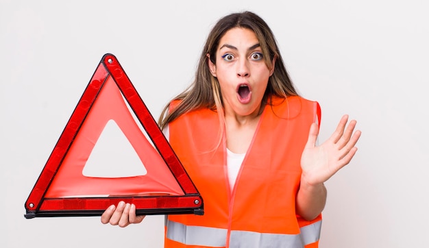 Photo pretty hispanic woman feeling extremely shocked and surprised car triangle concept