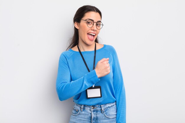 Pretty hispanic woman feeling happy and facing a challenge or celebrating. accreditation concept