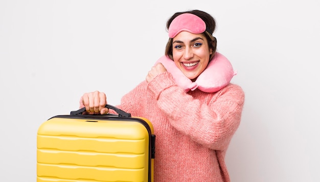 Pretty hispanic woman feeling happy and facing a challenge or celebrating flight passenger concept