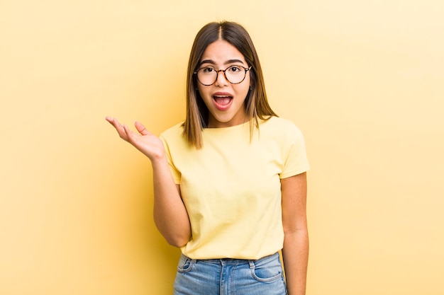 Pretty hispanic woman feeling happy surprised and cheerful smiling with positive attitude realizing a solution or idea