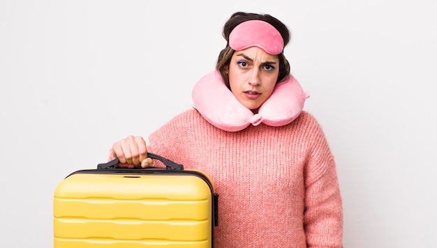 Pretty hispanic woman feeling puzzled and confused flight passenger concept