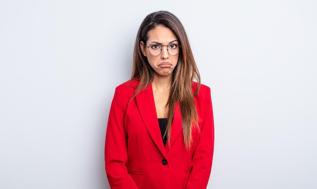 Pretty hispanic woman feeling sad and whiney with an unhappy look and crying. businesswoman concept