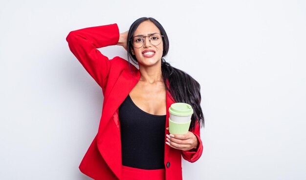 Pretty hispanic woman feeling stressed, anxious or scared, with hands on head. take away concept