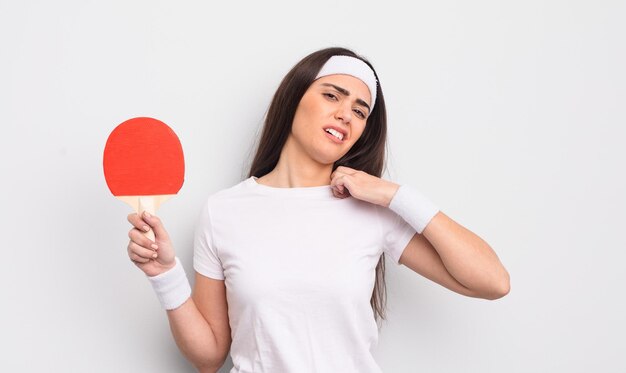 Pretty hispanic woman feeling stressed, anxious, tired and frustrated. ping pong concept