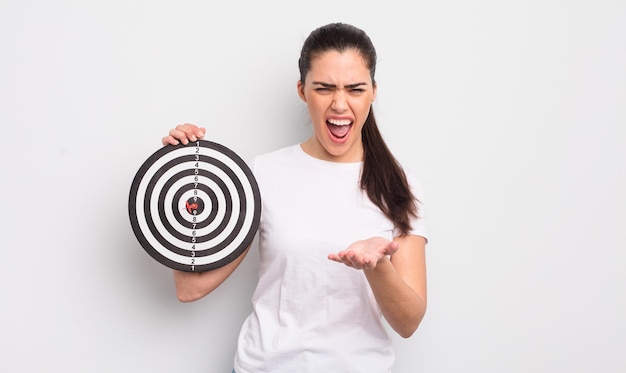 Pretty hispanic woman looking angry, annoyed and frustrated.darts target concept