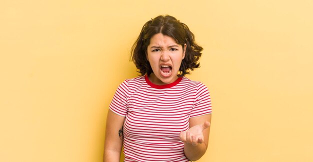 Photo pretty hispanic woman looking angry annoyed and frustrated screaming wtf or what's wrong with you