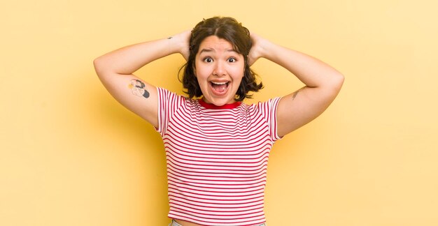 pretty hispanic woman looking happy carefree friendly and relaxed enjoying life and success with a positive attitude