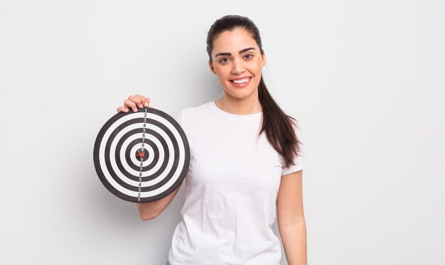 Pretty hispanic woman looking happy and pleasantly surpriseddarts target concept