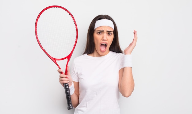 Pretty hispanic woman screaming with hands up in the air tennis concept