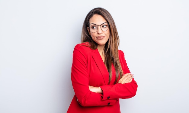 Pretty hispanic woman shrugging, feeling confused and uncertain. businesswoman concept