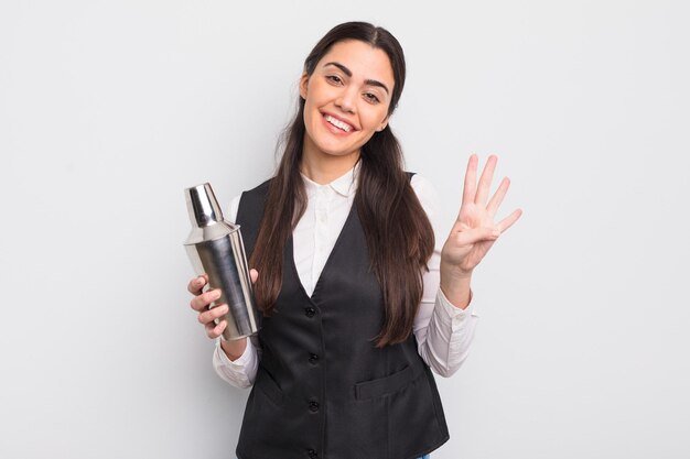 pretty hispanic woman smiling and looking friendly, showing number four. barman cocktail concept