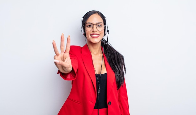 Pretty hispanic woman smiling and looking friendly, showing number three. telemarketing concept