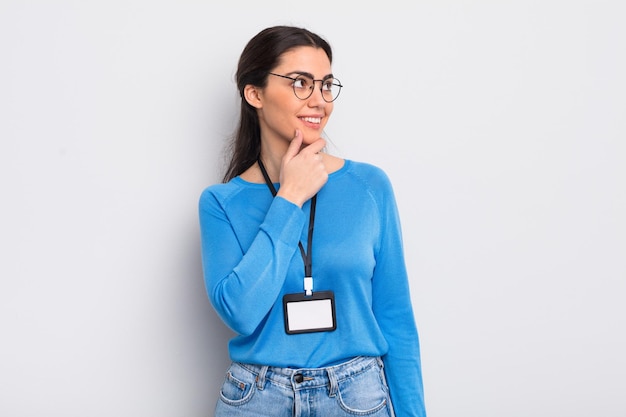 Pretty hispanic woman smiling with a happy confident expression with hand on chin accreditation concept