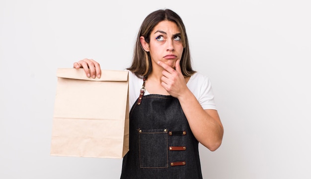 Pretty hispanic woman thinking feeling doubtful and confused delivery and take away concept