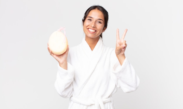 Pretty hispanic woman wearing bath robe after a shower