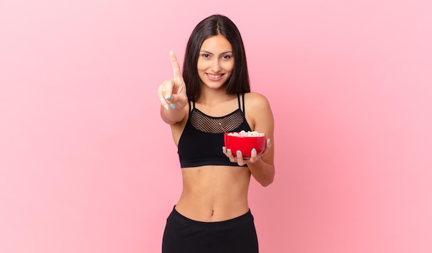 Pretty hispanic woman with a diet breakfast bowl