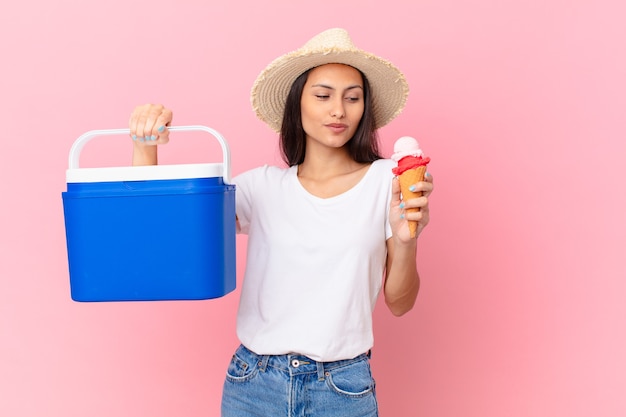 Pretty hispanic woman with a portable freezer and an ice cream