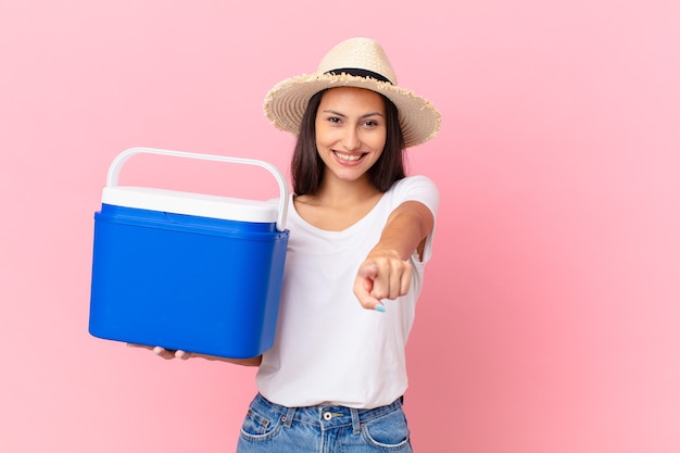 Pretty hispanic woman with a portable freezer