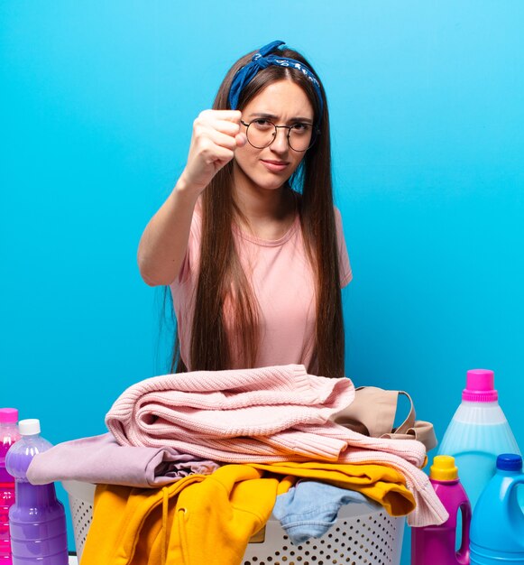 Pretty housekeeper woman washing clothes