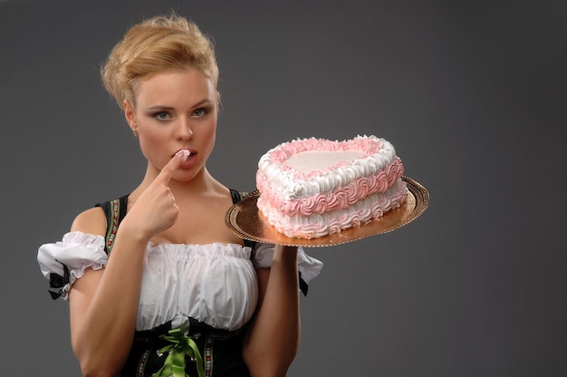 Фото Красивая домохозяйка с большим тортом на блюде