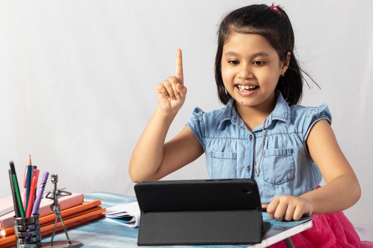 फोटो a pretty indian girl child attending online class with tablet on white background