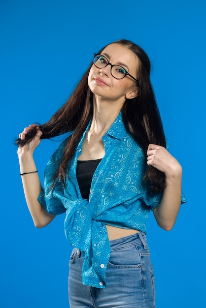 Pretty joyfully teen female with brown hair dressed casually looking at camera goodlooking beautiful