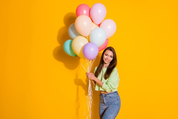 pretty lady hold many air balloons party guest