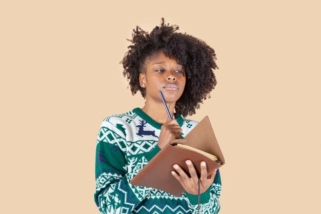 Pretty latin hispanic woman, writing letter at christmas