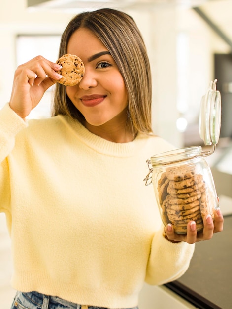 Pretty latin woman with home made cookies bottles