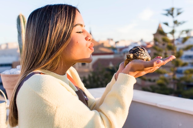 Pretty latin woman with a tortoise pet