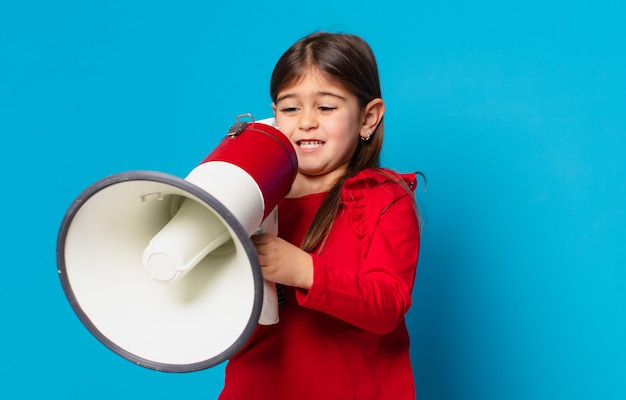 pretty little girl angry expression and holding a megaphone