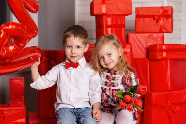 Pretty little girl and boy celebrating saint valentine day