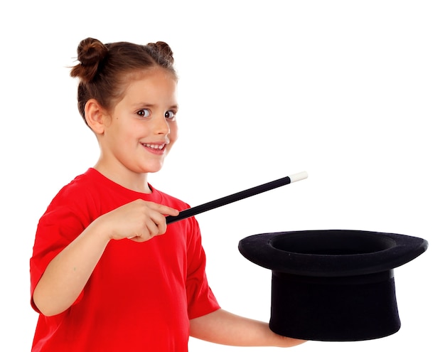 Фото Довольно маленькая девочка делает магию с верхней шляпой и волшебной палочкой