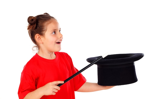 Pretty little girl doing magic with a top hat and a magic wand