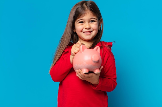 Pretty little girl happy expression and holding a piggy bank