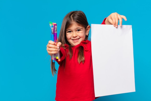 Pretty little girl happy expression an a sheet of paper