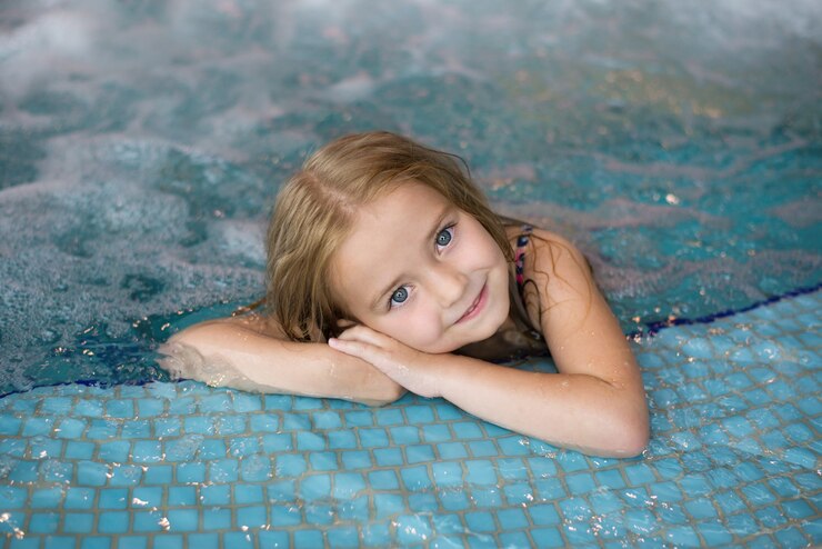 Pretty little girl in an indoor pool at a water park