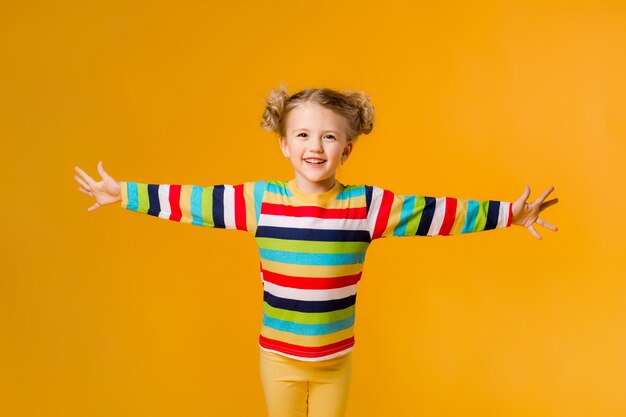 Pretty little girl posing in a studio