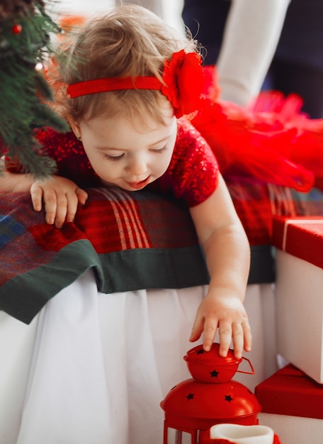 Pretty little girl in red dress looks funny 