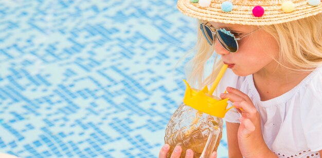 Pretty little girl in swimming pool, summer vacations.