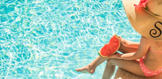 Pretty little girl in swimming pool, summer vacations.