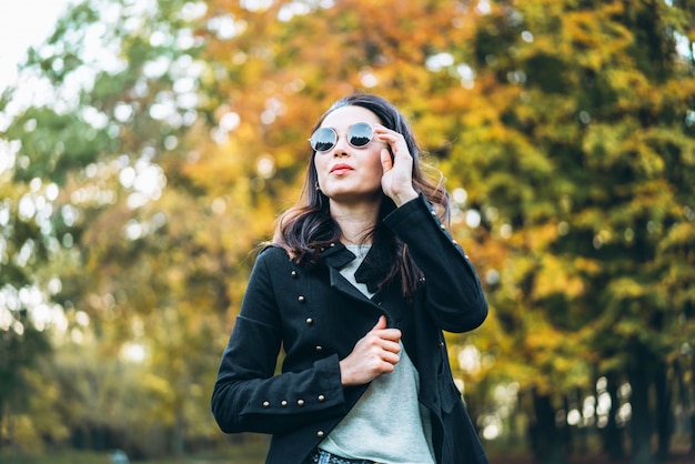 Pretty long hair brunette girl relaxing in the park