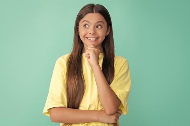 Pretty look of young girl face portrait of child on blue background express positive emotions