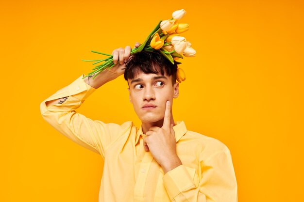 Pretty man give flowers wear spectacles yellow shirt isolated background unaltered