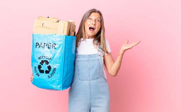pretty middle age woman feeling happy and astonished at something unbelievable recycling cardboard concept