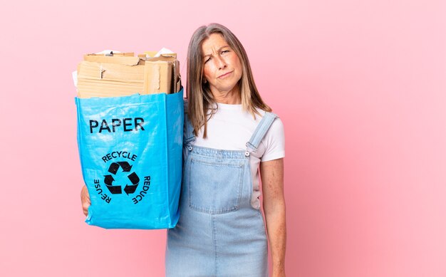 Pretty middle age woman feeling sad, upset or angry and looking to the side recycling cardboard concept