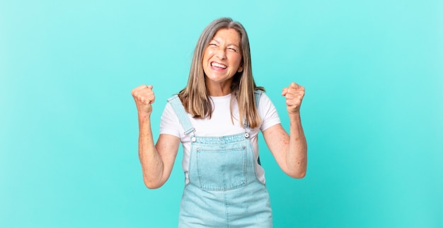 pretty middle age woman feeling shocked,laughing and celebrating success